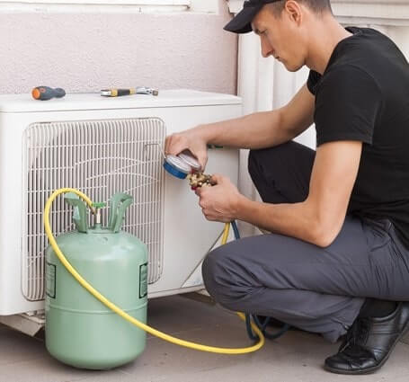 Thumbnail of a technician evaluating refrigerant for small A/C unit
