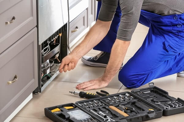 HVAC-technician-repairs-refrigerator