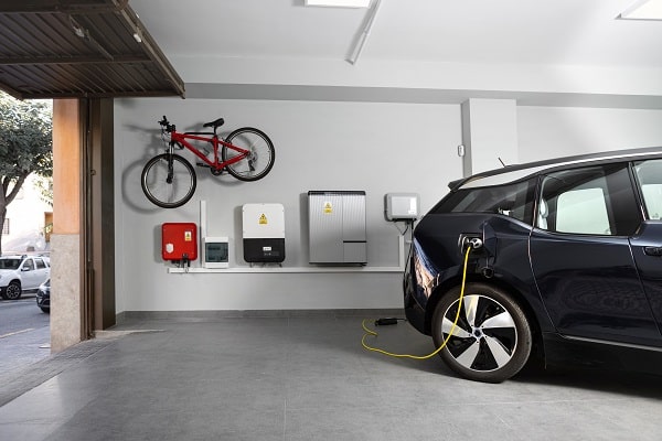 An electric vehicle charging station installed in a garage by an electrician