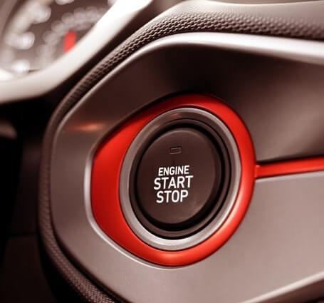 Thumbnail of an engine start/stop button in a red sports car signals the changing future of auto mechanics
