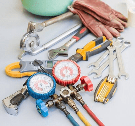 Thumbnail of HVAC tools, including gloves, wrenches and more lay on a white background